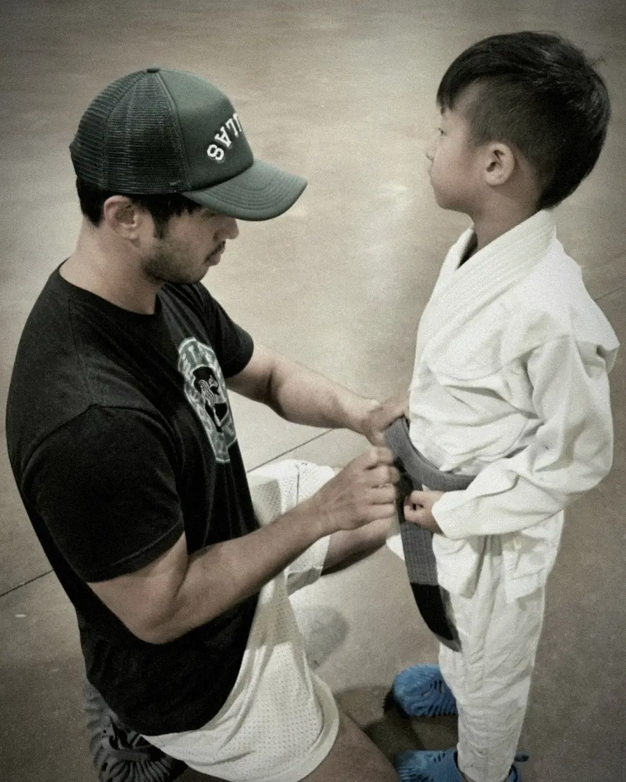 Brian coaching a child in Brazilian Jiu Jitsu