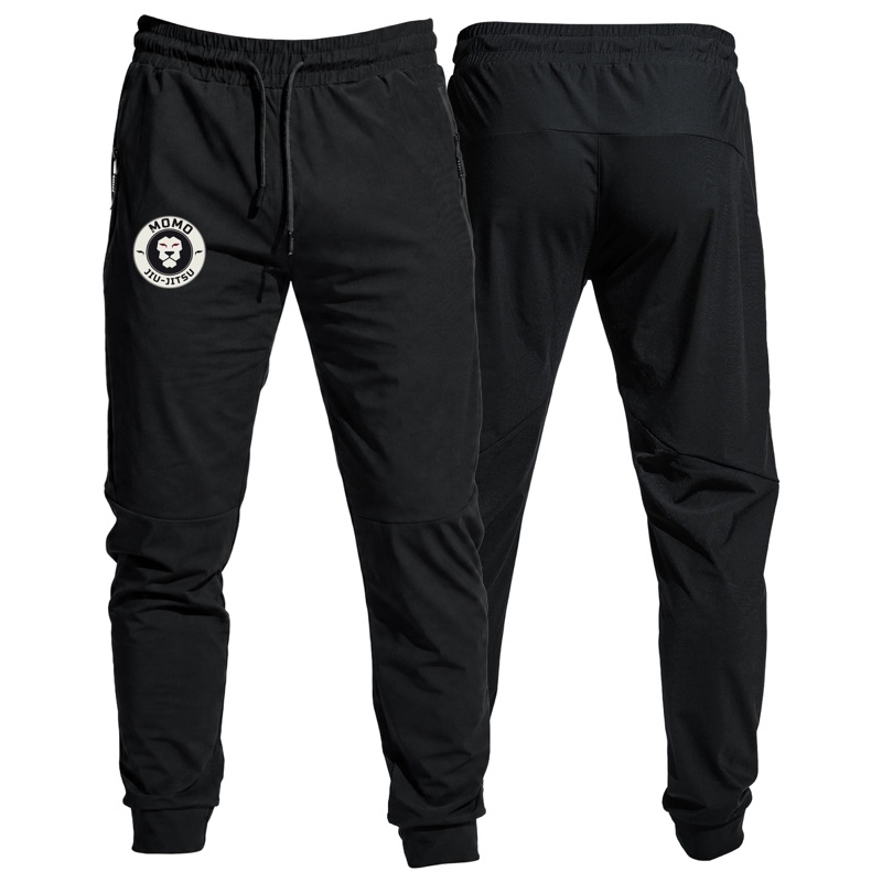 Black MOMO joggers with the round lion patch